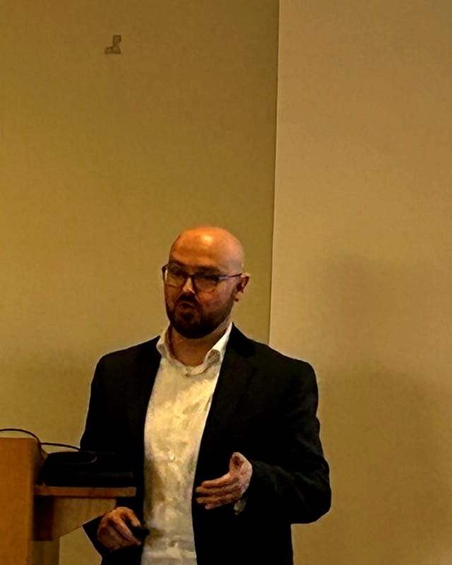Shane McLoughlin delivering a keynote on practical wisdom