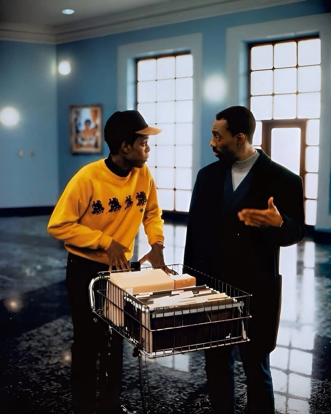 Two men talking next to a cart of documents, from the film Boomerang (1992) with Eddie Murphy