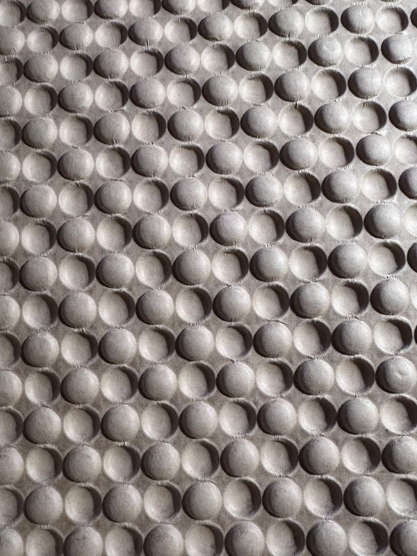 Dramatically lit embossed/debossed packing kraft paper that is almost like bubble wrap.