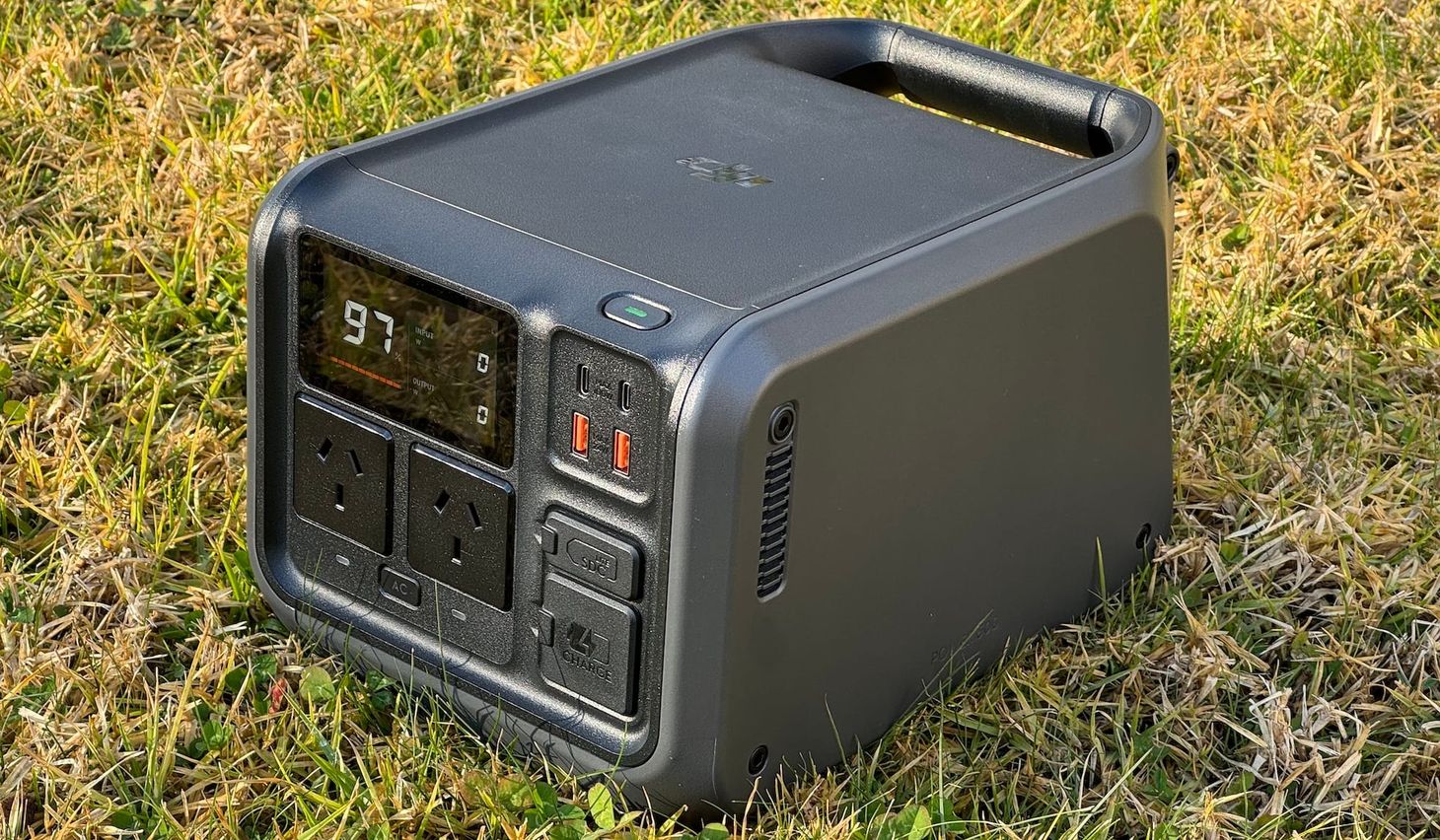 The DJI Power 500 power station sitting on grass.