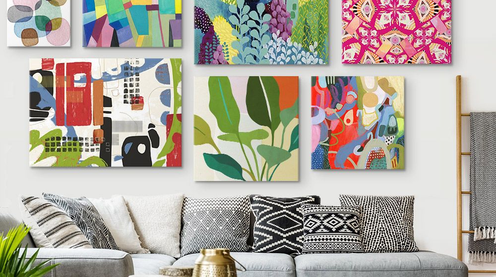 Gallery wall of vibrant canvas prints in over a couch in a Bohemian-styled Living Room