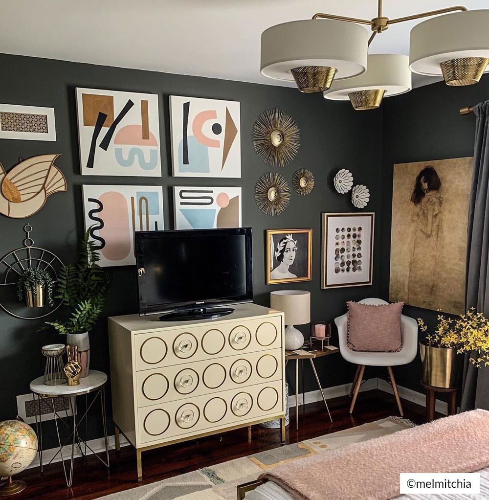 gallery wall in a bedroom displaying canvas art prints alongside sculptural wall décor