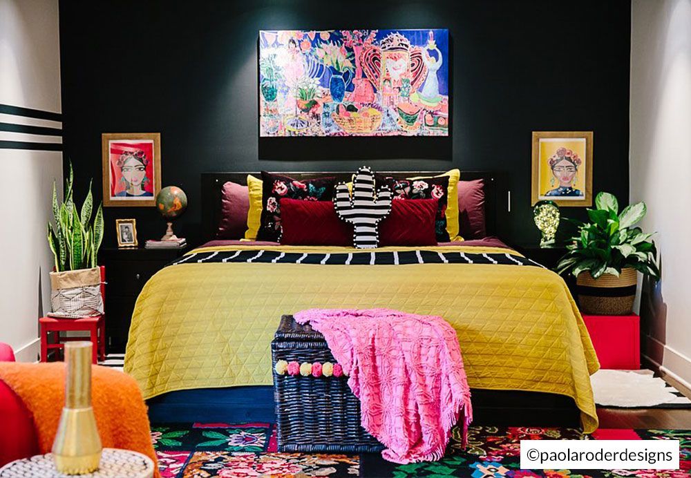 Brightly decorated boho-maximalist bedroom with a canvas print hung on an accent wall