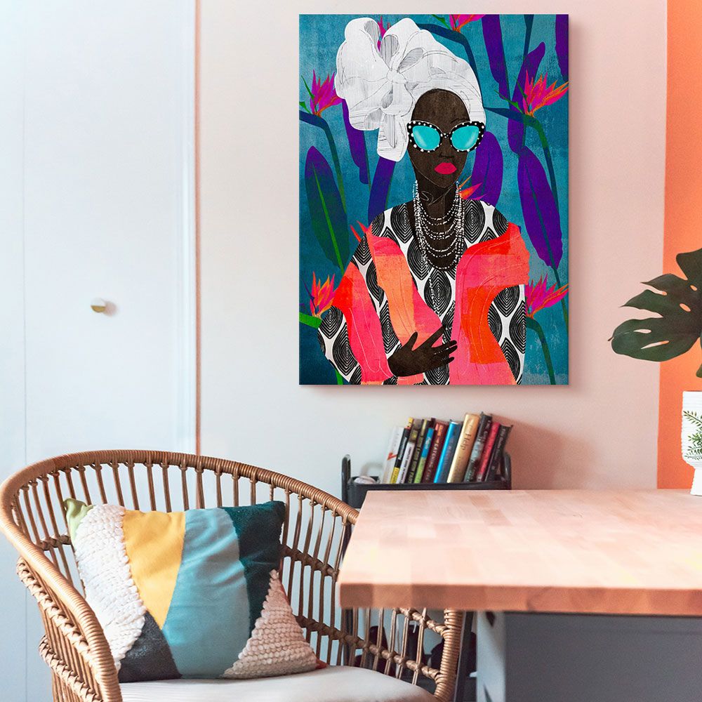 Brightly colored wall art hung on a wall of a bohemian-styled space