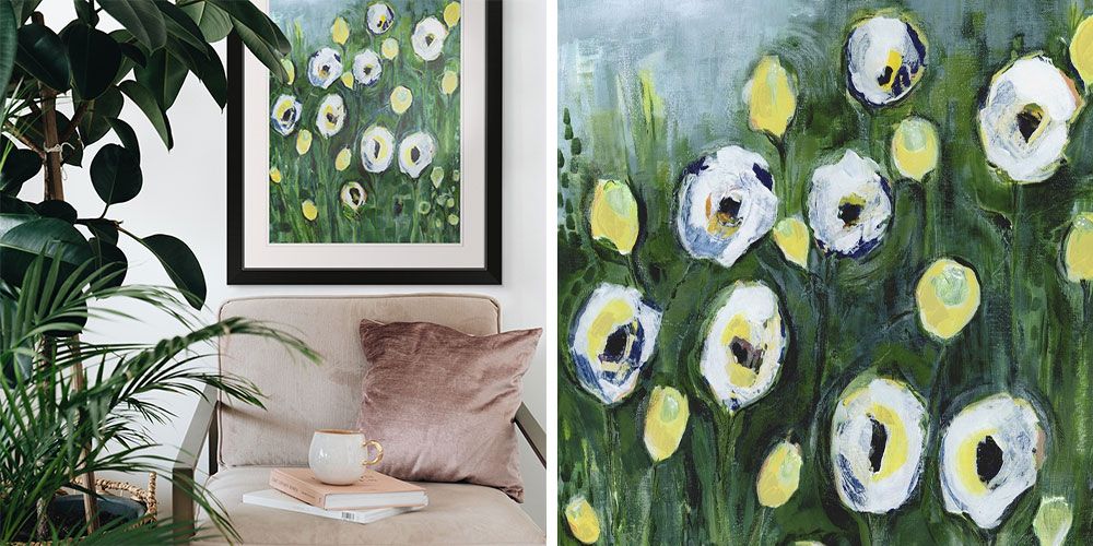 interior room with lush greenery, pink velvet chair and a framed print displaying flowers