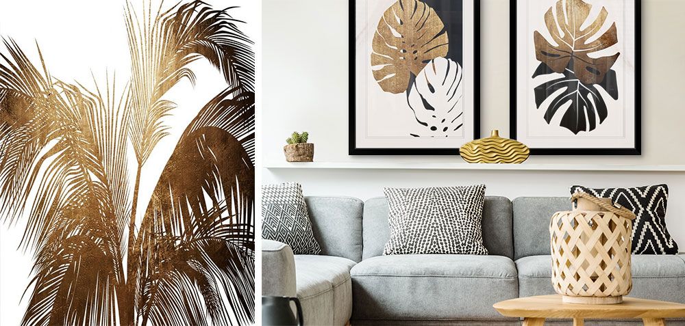 Two gold and black Monstera plant art prints in black frames over a gray couch.