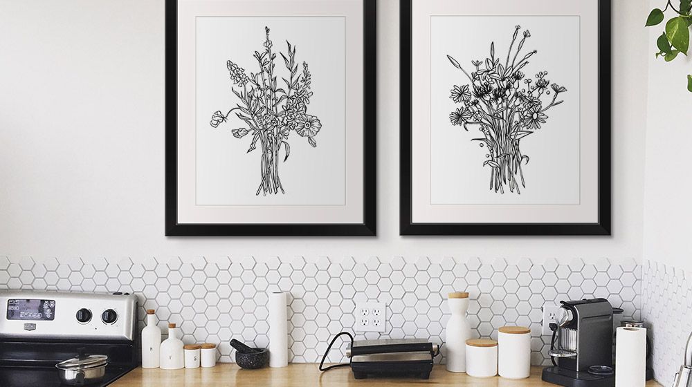 Two floral framed prints in a white modern kitchen
