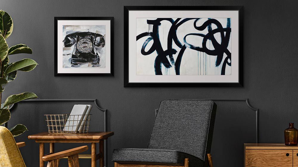Modern framed art prints in a dark modern office space