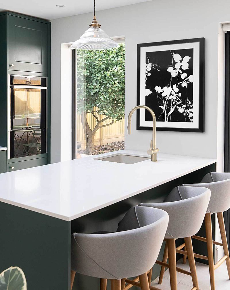 Black and white floral art print in a black frame with mat in a modern kitchen.