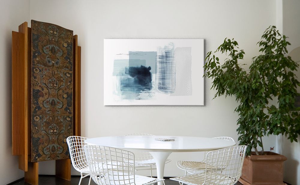 An abstract blue, gray, and white canvas over a modern white kitchen table.