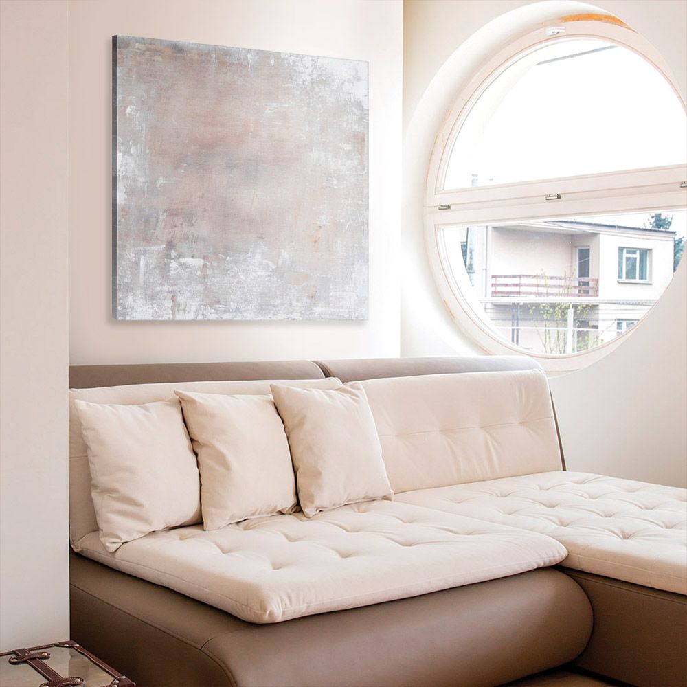 Neutral-toned abstract piece on canvas above a modern brown couch with futon-like cushions.