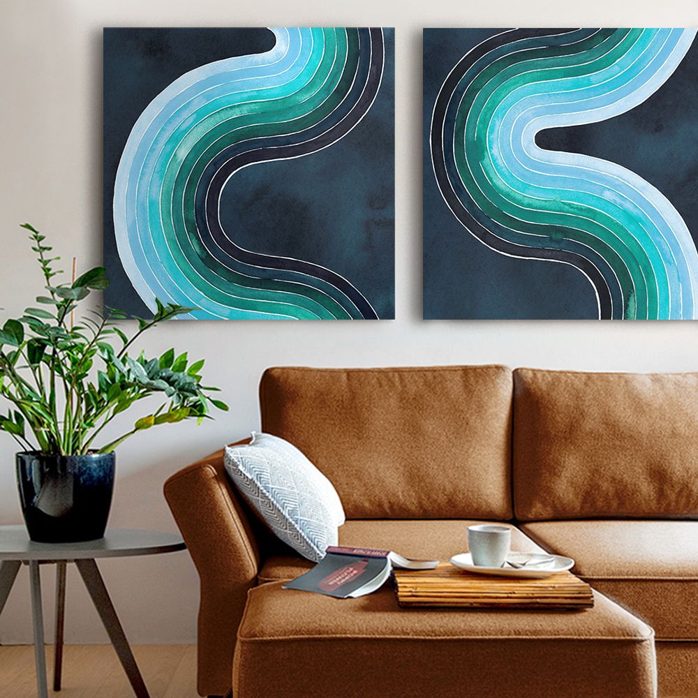 Two geometric wave designs in various tones of blue over a brown leather couch.