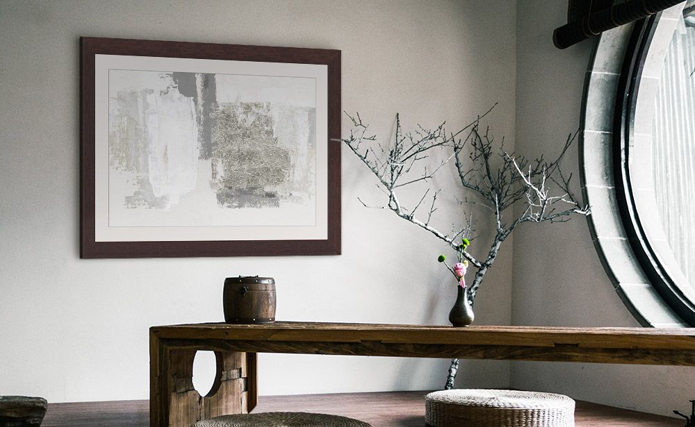 Neutral-toned abstract piece with a brown frame over a low Japanese-style table.
