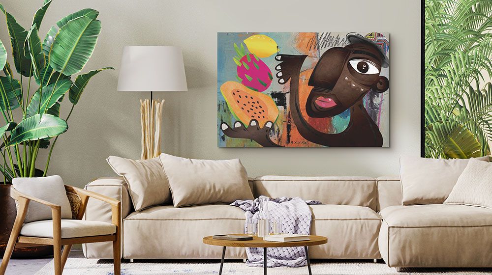 Melon Man Wall Art by Nikki Chu hung over a low backed sofa with large topical indoor plants