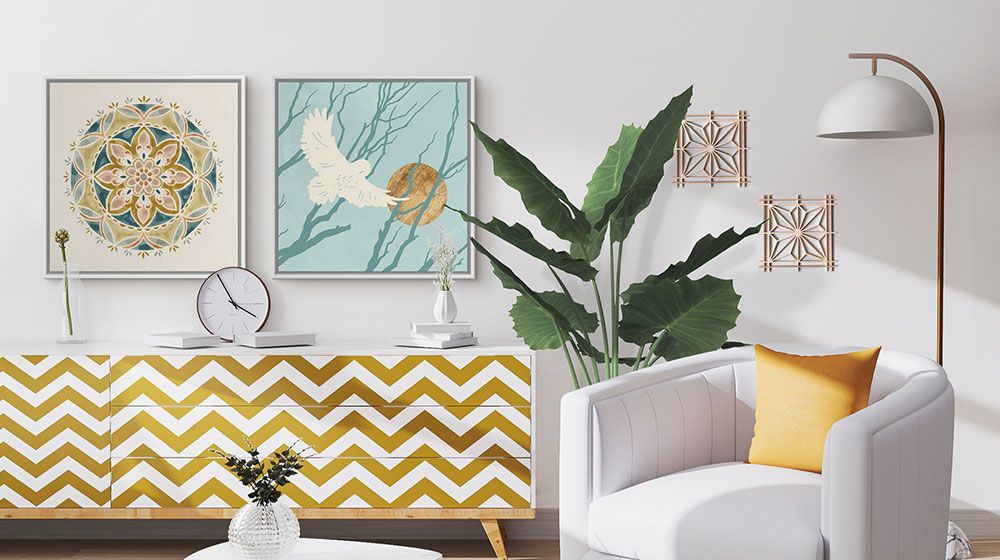 Two wall art pieces mounted above a cabinet, Summer Mandala III by Victoria Borges, and Silent Hunter IV by Jacob Green