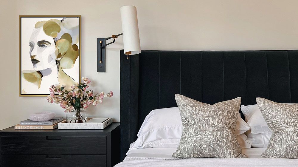 Organic Portrait I Wall Art by Victoria Borges above a black nightstand next to a black felt covered head board