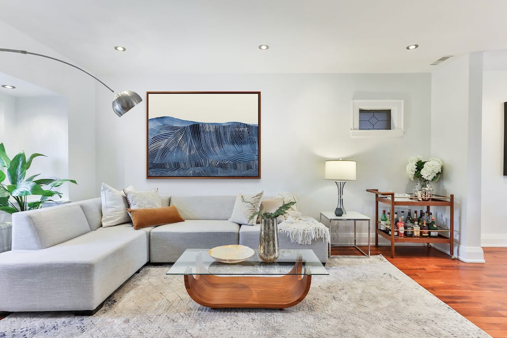 Contemporary living room with modern decor featuring an oversized painting.