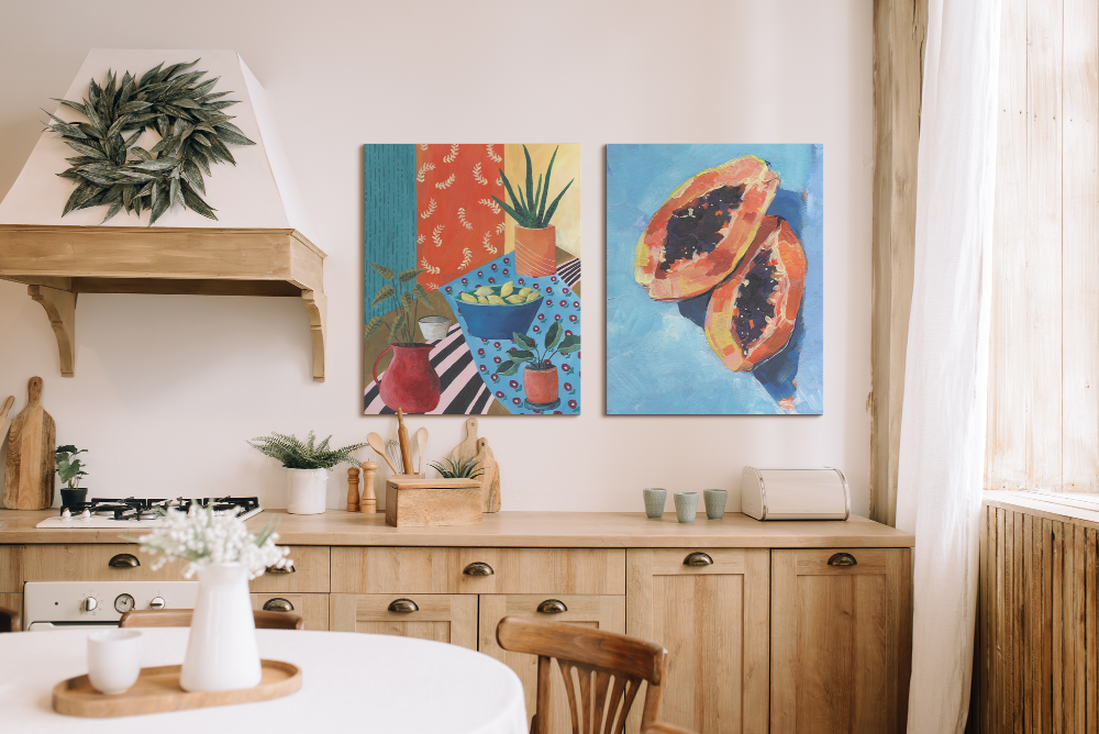 Two colorful canvas wall art pieces displayed above a rustic kitchen countertop.