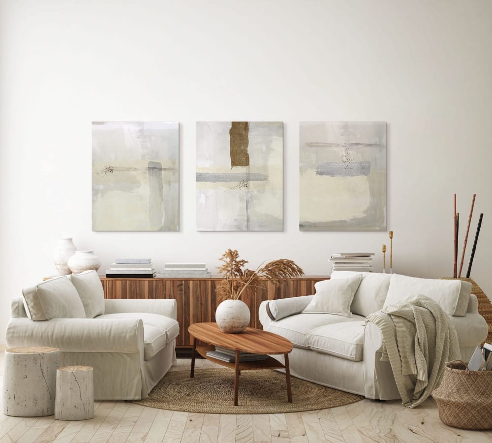 three minimalist canvas artworks on a white wall