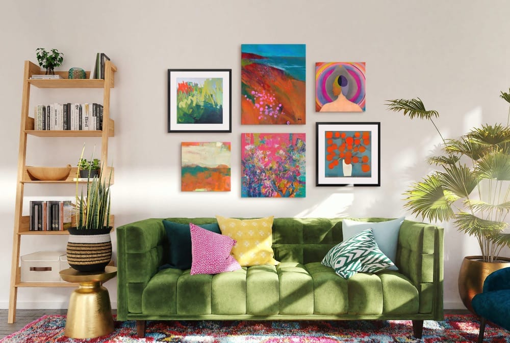 eclectic gallery wall above a green velvet couch in a maximalist living room