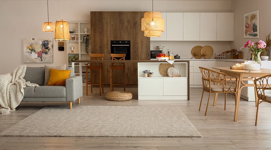 Open-concept living and dining area with natural tones and abstract wall art.