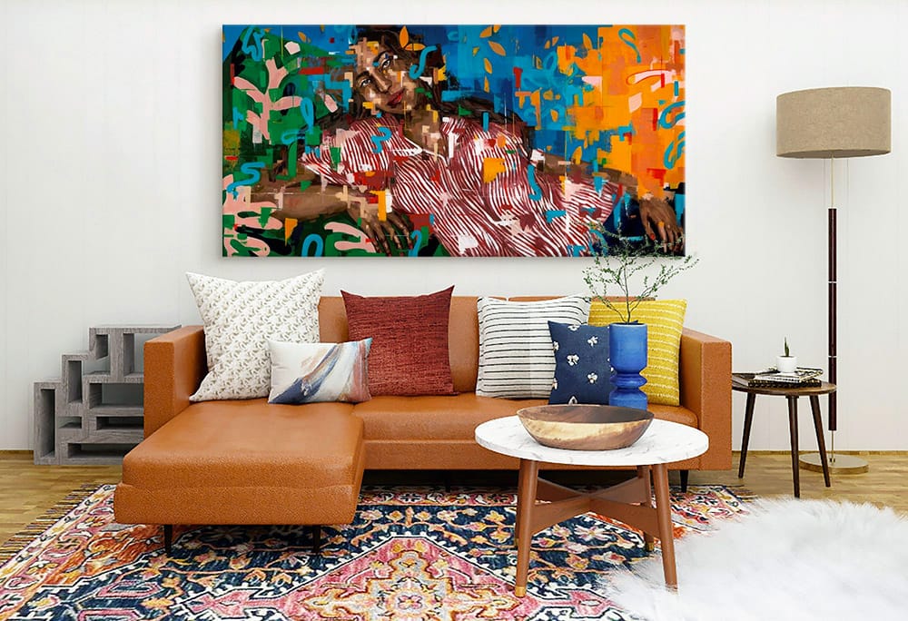 Large abstract portrait canvas print over a couch in a bohemian living room