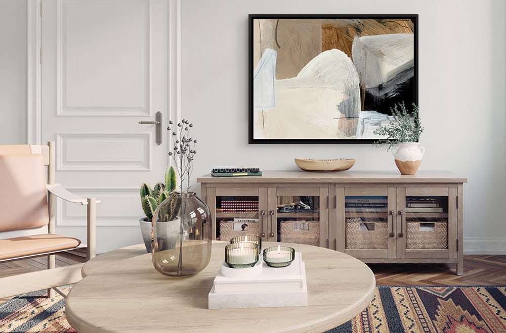 Neutral abstract canvas print in a black floating frame in a modern living room