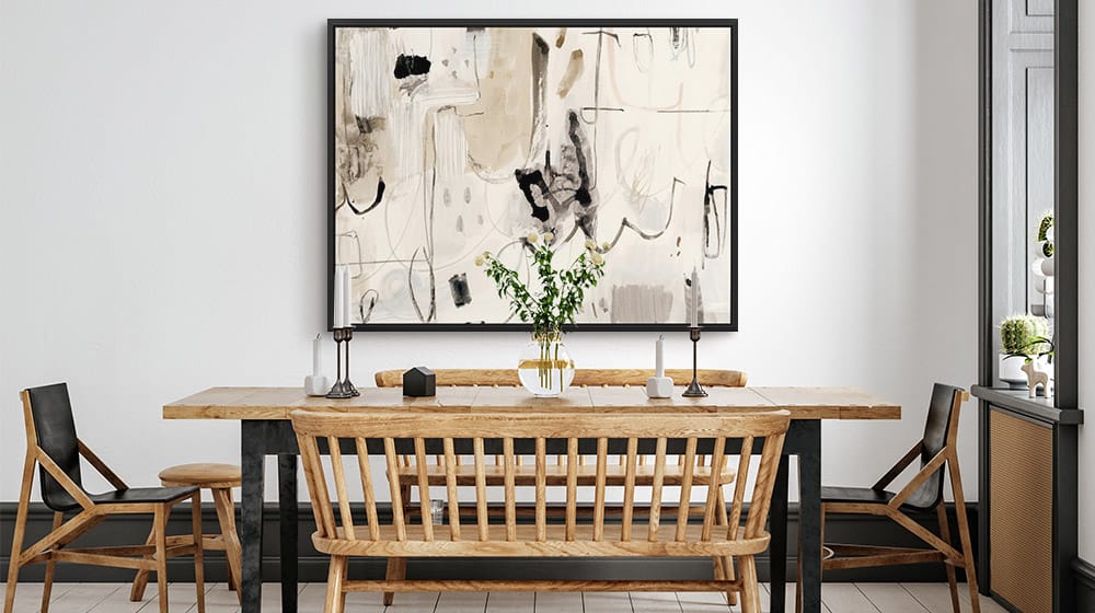 Neutral canvas print in a black floating frame in a large dining room