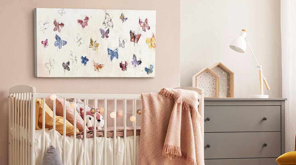Abstract butterfly canvas art print on the wall in a soft feminine nursery