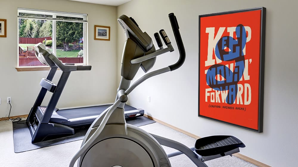 Large motivational typography framed canvas in a home gym