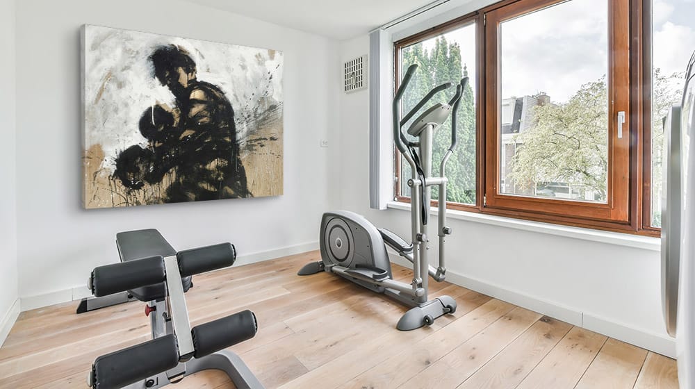 Large canvas print on the wall in a bright open home gym
