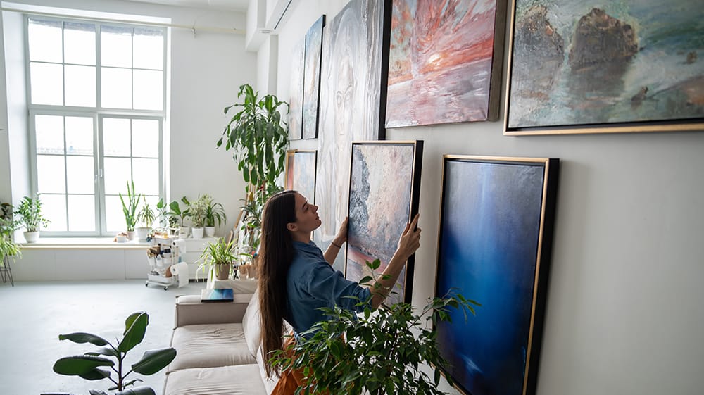 Gallery wall arrangement showing how to choose wall art scale and layout based on ceiling height in a bright open living space