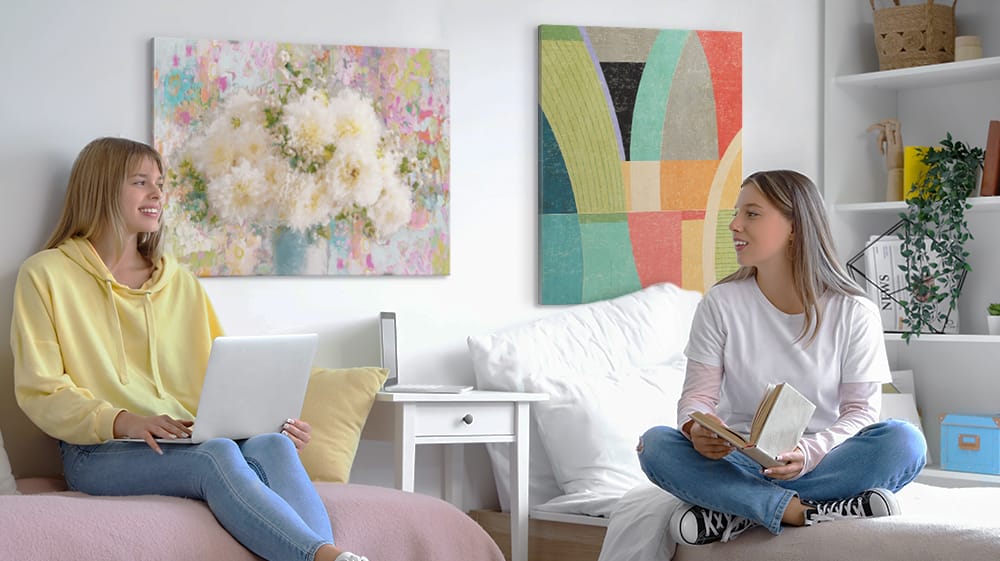 Shared dorm room with coordinated wall art above beds, showing how to create a cohesive and balanced layout with multiple prints