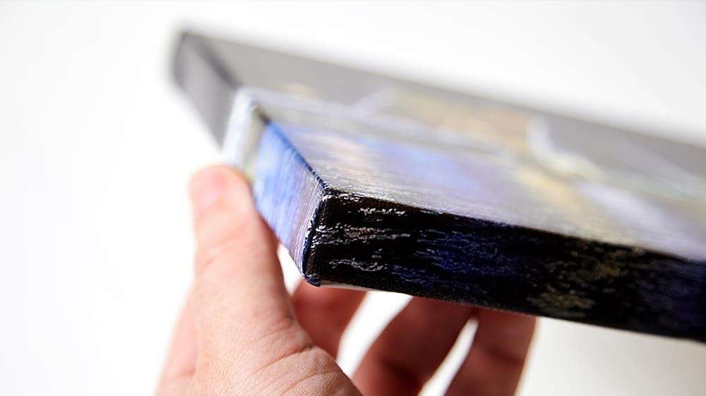 Close-up of canvas print edge showing textured canvas fabric and wrapped corners for a high-quality finish
