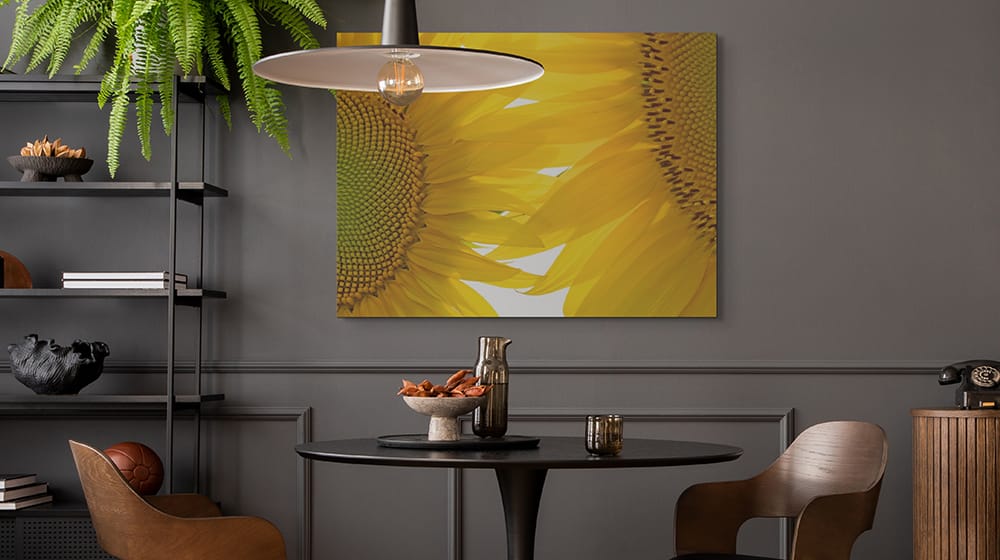 Large sunflower nature canvas wall art brightening a modern dining room with warm natural color and botanical detail