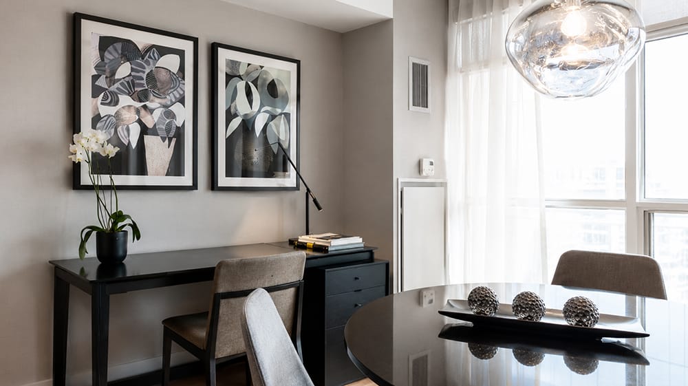 Compact dining and work area with paired abstract prints showing how modern wall art can add interest to a functional room