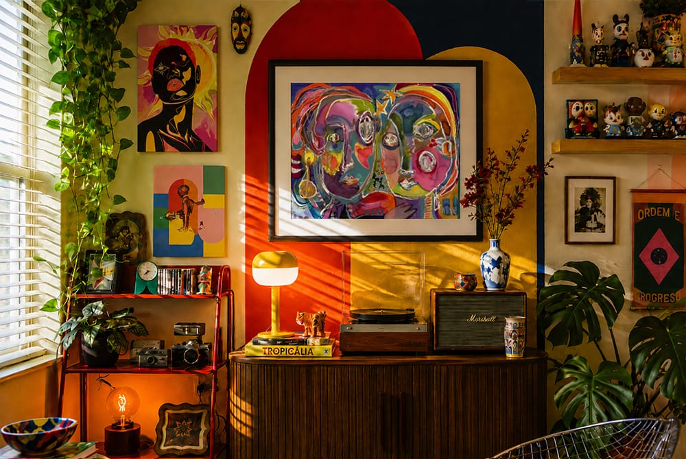 Retro-inspired global maximalist corner with vibrant wall art, graphic color blocking, plants and playful collected objects.
