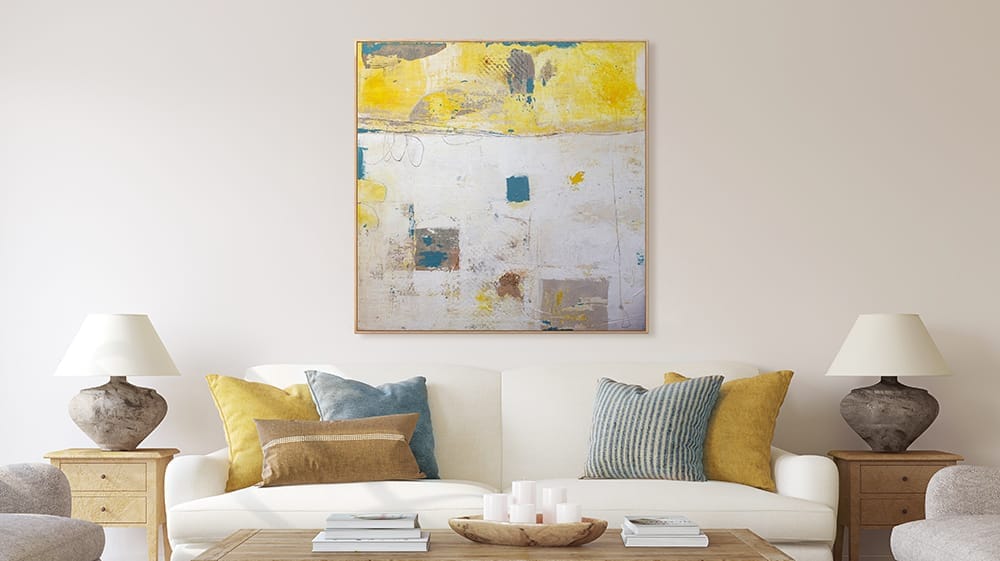 Yellow and neutral abstract canvas wall art above sofa, showing how warm tones in abstract art create a bright, uplifting atmosphere