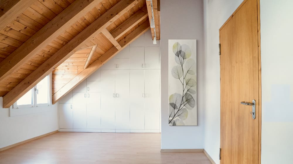 Tall botanical canvas wall art fills a narrow section of wall beside a bedroom doorway, showing how art can make use of an easily overlooked space behind a door.