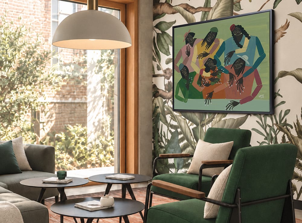 Colorful figurative artwork of a group of Black figures hangs in a botanical-inspired sitting room with green chairs.