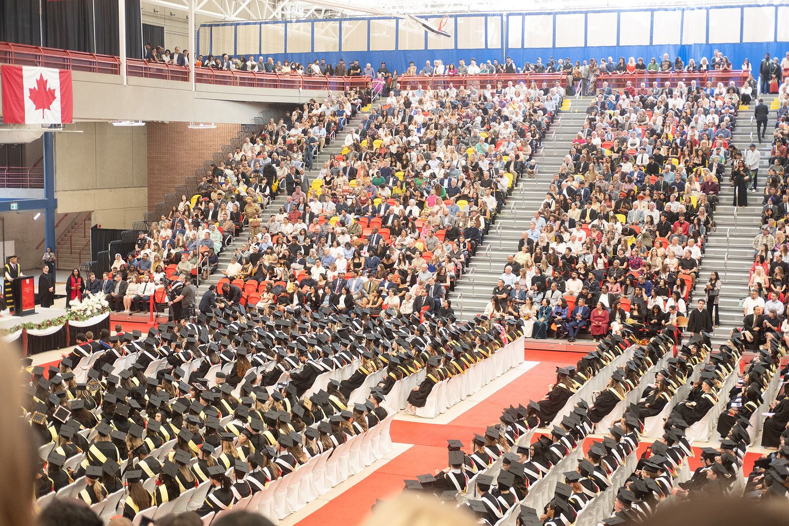 Audience members shout chants during convocation ceremonies