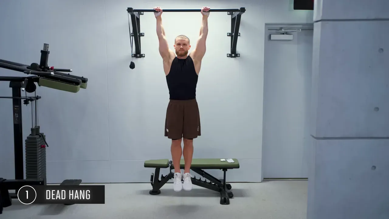 Beginner demonstrating dead hang from pull-up bar