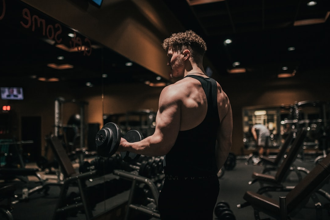 man lifting weights back at the gym training comeback