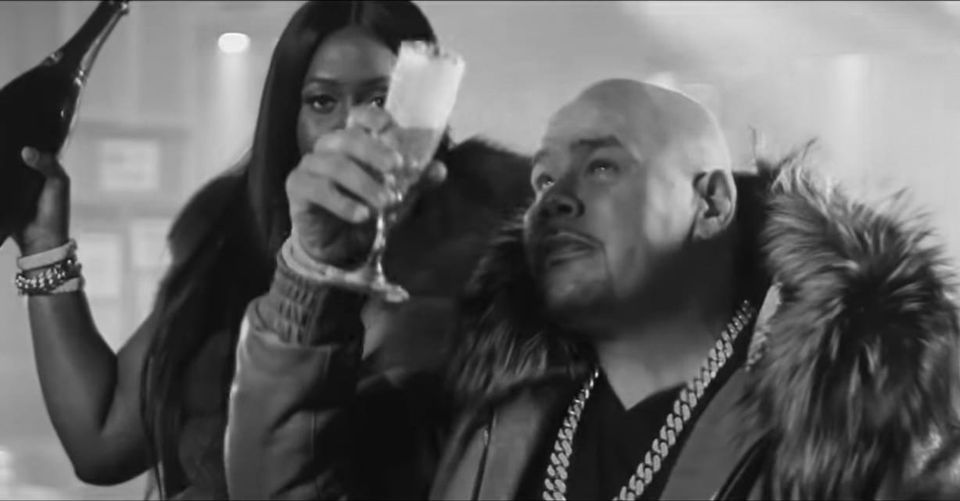 Fat Joe and Remy Ma toasting their success while wearing garish fur coats.