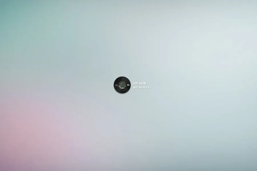 Source preview of Vynil Player: A disc-shaped player with track artwork, side navigation buttons and the song name shown to the right