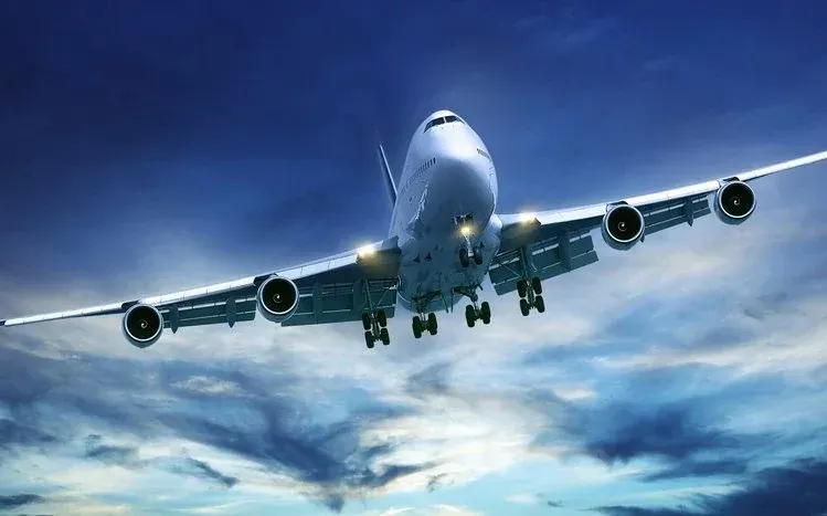 Airplanes at airports, on runways, and flying among clouds.