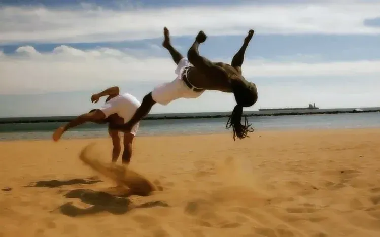 Capoeira-themed wallpapers focused on the Brazilian practice combining martial movement, dance, and acrobatics.