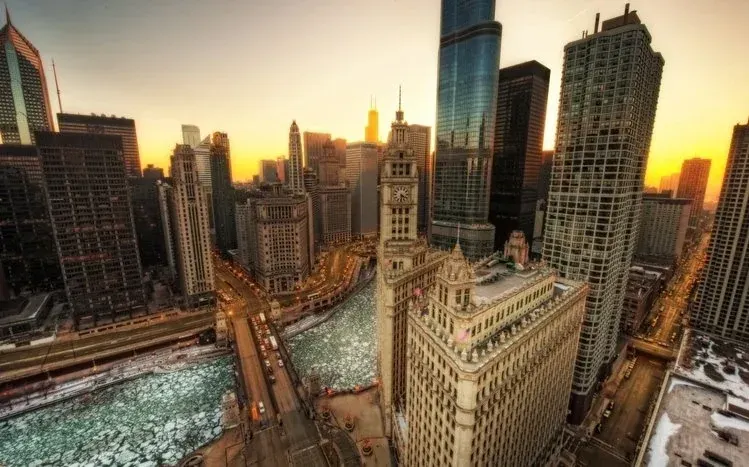 Chicago buildings rising toward clouds and sky.