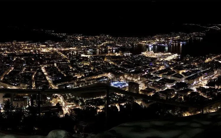 Panoramic city wallpapers with illuminated towers, waterfronts, bridges, and roads for dual monitors.