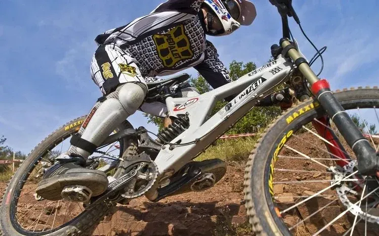Downhill biking shots with hillside scenery and surrounding landscapes.